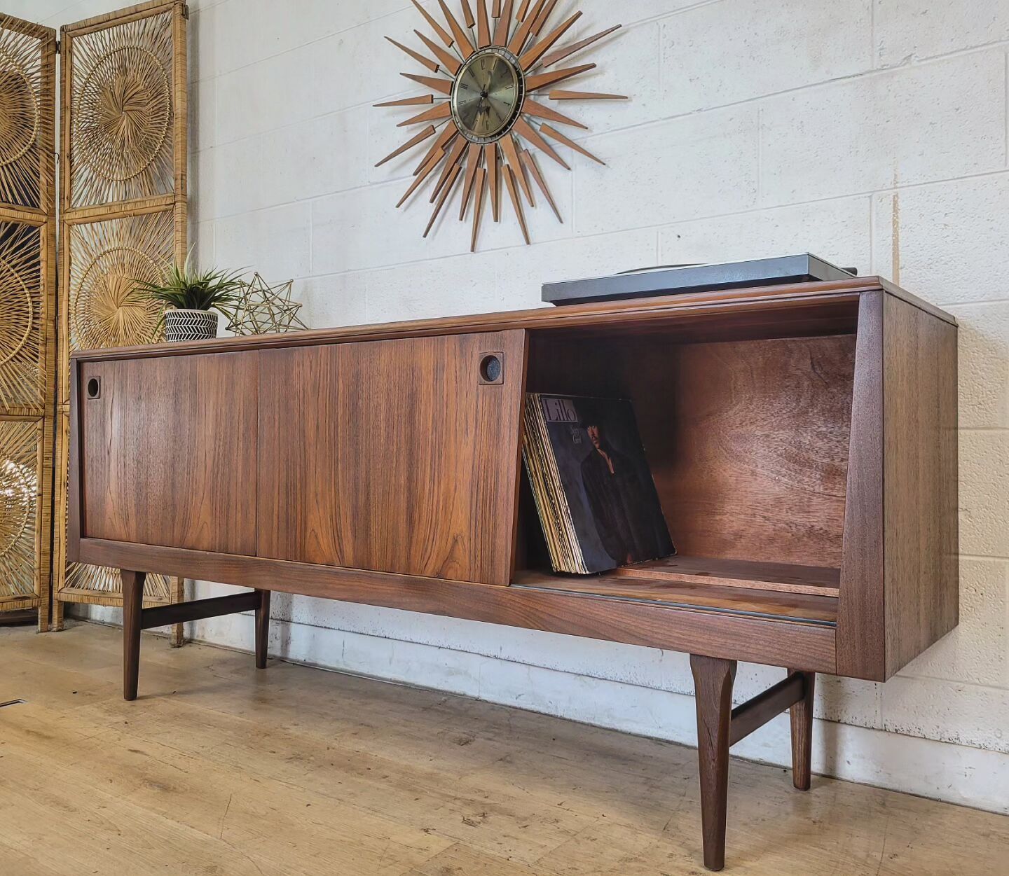 RHF Credenza with teak grain, tapered sides, and adjustable shelves, adding atomic style to home decor. 73w x 30.75t x 17.75d.