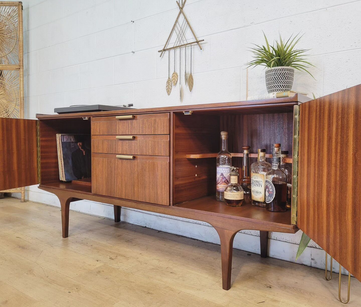 Vintage Meredew credenza with Zebrano wood, brass hardware, and adjustable shelves, stylishly restored for home decor.