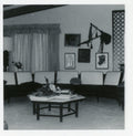 Vintage photo of a Harvey Probber travertine hexagon coffee table with a solid mahogany base in a mid-century modern living room.