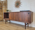 RHF Credenza with teak grain, tapered sides, and two shelves, giving an atomic vibe to home decor. Mid-century modern console.