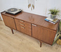 Meredew credenza in Zebrano wood with brass hardware, featuring adjustable shelves. Vintage piece with restored finish.