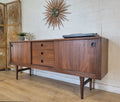 Mid-century modern teak RHF credenza with tapered sides, adjustable shelves, and atomic design, enhancing home decor.